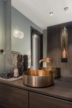 a bathroom with a sink, mirror and lights on the wall above it's counter