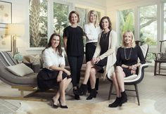 a group of women sitting next to each other in front of a living room window