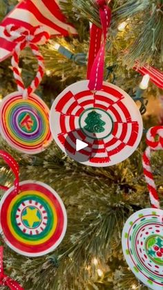 an ornament hanging from the christmas tree with red, white and green ornaments