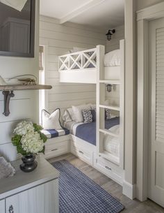 a bedroom with bunk beds and white furniture