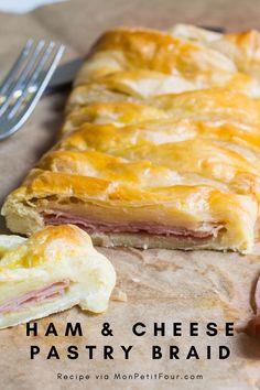 ham and cheese pastry bread on a piece of parchment paper with a fork next to it