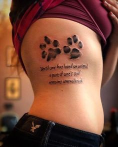 a woman with a tattoo on her stomach that says, what one has loved an animal