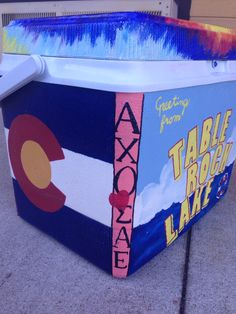 a cooler with the flag of colorado painted on it's side and words that read, table rock lake