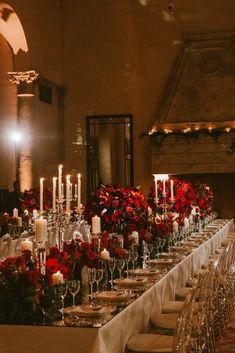 a long table is set with candles and flowers for a formal dinner or banquet event