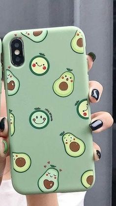 a woman holding up a phone case with avocado faces on the front and sides