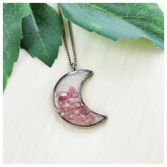 "Handmade strawberry quartz and rose quartz crescent moon bezel resin pendant necklace. Pendant Size: See Pics For Measurements & Size Scale Comparisons Chain Length: My pendant necklaces are made with a standard \"Princess\" length 18\" chain; I also offer custom length options. Choose your custom length by using the \"Necklace length\" drop-down menu located just above the add to cart button* (*length reference chart shown in pics) Colors: Pastel Pink, Dark Magenta Pink, Pearl White, Gunmetal Silver Gray Materials: Pendant: Strawberry Quartz Chips, Rose Quartz Chips, Resin, & Silvertone Stainless Steel Chain: Gunmetal Silvertone Stainless Steel (due to a variety of monitor/screen settings, IRL color may vary slightly, pics taken in natural light)" Half Moon Metal Necklace For Gifts, Half Moon Metal Necklace For Gift, Silver Resin Spiritual Necklace, Silver Spiritual Resin Necklace, Round Crystal Necklace With Moon Charm For Jewelry Making, Pink Moon Charm Jewelry, Pink Round Moon Charm Jewelry, Bohemian Silver Resin Jewelry, Half Moon Metal Jewelry Gift