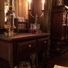 an old fashioned dresser with candles on it