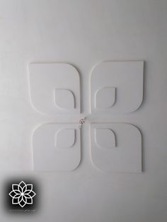 four pieces of white plastic sitting on top of each other in the shape of squares