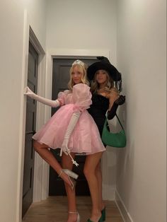 two women dressed in costumes posing for the camera