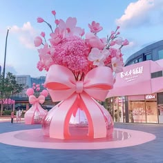 a large pink vase filled with lots of flowers