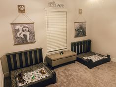 two beds in a room with pictures hanging on the wall and carpeted flooring