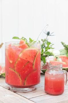 watermelon juice in a pitcher and jar on a wooden table