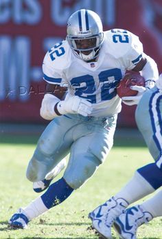 a football player is running with the ball