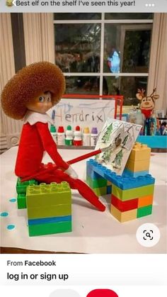 an elf is sitting on top of legos with the caption best elf on the shelf i've seen this year