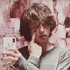 a young man taking a selfie with his cell phone