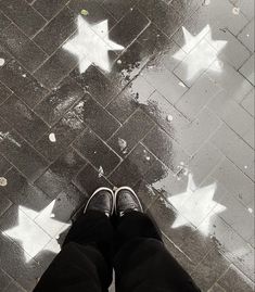 a person standing in front of white stars on the ground