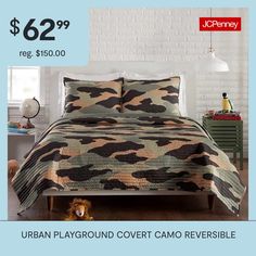 the bed is made up and has a camo pattern on it, with an image of a teddy bear next to it