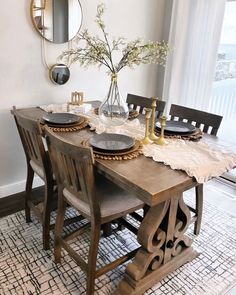 a dining room table with plates and place settings