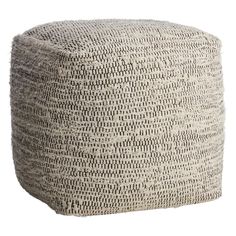 an ottoman that has been made out of woven fabric and is sitting on a white background