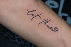 a person with a tattoo on their arm that says faith in cursive writing