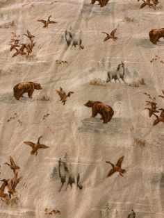 an animal themed sheet with birds and bears on it