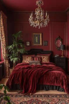 a bedroom with red walls and a chandelier hanging from the ceiling