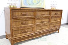 a large wooden dresser with wicker drawers