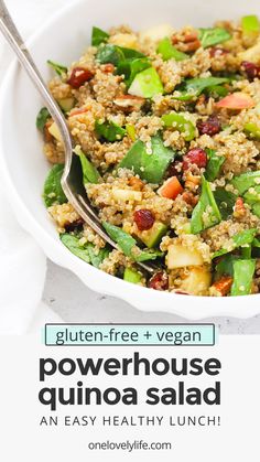 a white bowl filled with quinoa salad on top of a table next to a fork