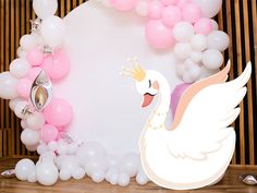 there is a swan and balloons on the table