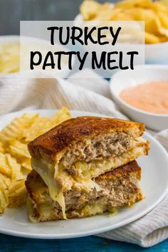 a turkey patty melt sandwich on a plate with french fries