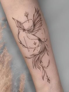 a woman's arm with a bird tattoo on the left side of her body