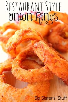 an image of onion rings on a cutting board with the title restaurant style onion rings six sisters'stuff