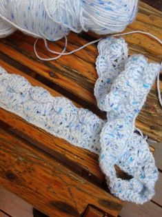 two crocheted items sitting on top of a wooden table