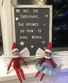 two elfs sitting on top of a window sill next to a sign that says we met the tooth fairy, she showed us how to make wings