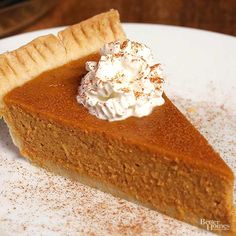 a slice of pumpkin pie with whipped cream on top