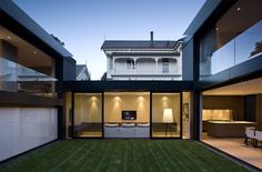 an open living room and dining area in a modern house with large sliding glass doors