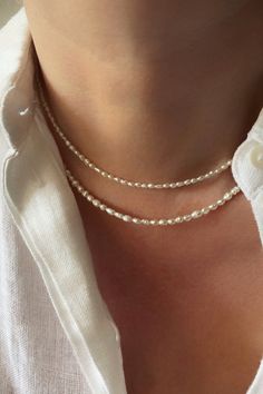 Lovely dainty freshwater pearl necklace! Simple yet feminine, this necklace features tiny seed natural white pearls. It is perfect on its own or layered with some of your favourite necklaces. You will love it! With its classic and vintage vibe this genuine pearl necklace would be a great piece for everyday or a boho wedding. #pearls #necklacesjewelry #daintyjewelry #daintynecklace Dainty Pearl White Beaded Necklaces With Pearl Pendant, Dainty Pearl White Beaded Necklace For Everyday, Handmade Dainty Pearl Necklace, Minimalist Pearl White Beaded Necklaces With Pearl Charm, Minimalist Pearl White Beaded Necklace With Pearl Charm, Minimalist Pearl Necklace With Tiny Beads, Dainty Pearl White Beaded Necklaces With Pearl Chain, Delicate Everyday Beaded Necklace With Pearl Chain, Minimalist Pearl Beaded Necklace For Everyday