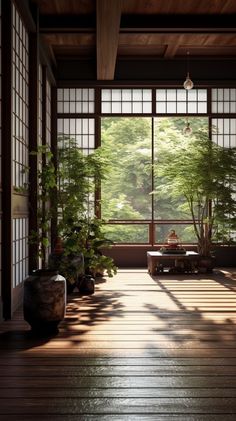 an empty room with large windows and plants on the floor, in front of it