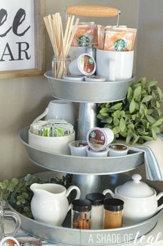 a three tiered tray with coffee cups and other items