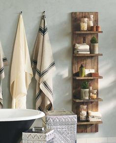 a bath room with towels hanging on the wall