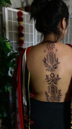 a woman with a tattoo on her back