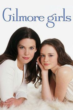 two young women laying on top of a fluffy white blanket