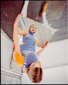 a woman is upside down in the air