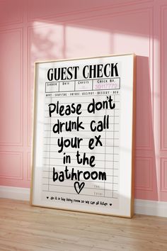 a bathroom sign with the words guest check written on it in black ink against a pink wall