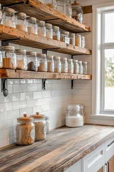 the shelves in this kitchen are filled with jars