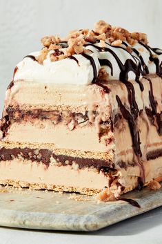 a piece of ice cream cake with nuts on top