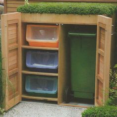 an outdoor storage shed with several bins in it