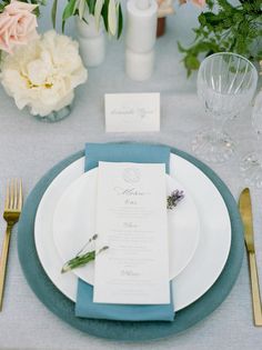 a place setting with flowers and silverware