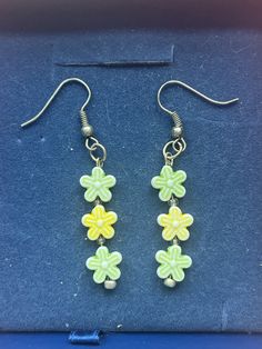 Multicolored Flower dangling Earrings  * Handmade Jewelry  * Flower shaped beads  * 2 green flowers, 1 yellow flower Gift wrapped upon arrival when requested from buyer. Green Flower Earrings For Gifts, Yellow Flower-shaped Jewelry With Flower Decoration, Elegant Yellow Flower-shaped Jewelry With Flower Decoration, Handmade Green Dangle Flower Earrings, Green Beaded Flower Drop Earrings, Green Beaded Drop Flower Earrings, Green Dangle Flower Earrings For Gift, Handmade Green Flower Drop Earrings, Green Dangle Jewelry With Flower Charm