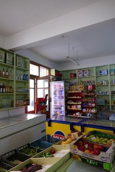 a grocery store filled with lots of fresh fruits and vegtables on display